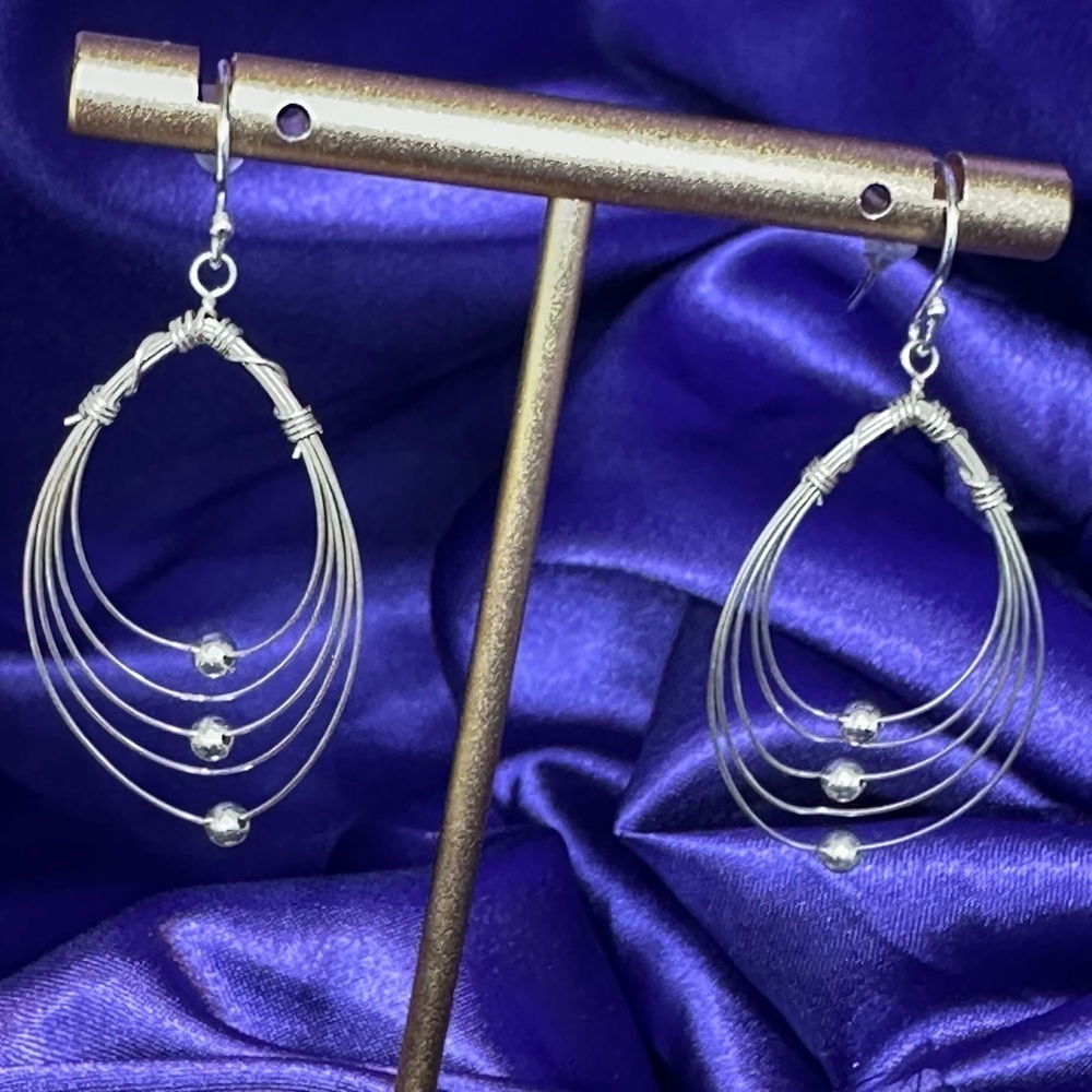 Multi Hoops with moving silver balls dangle earrings.